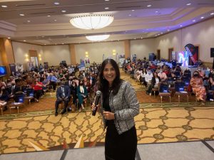 Beatriz Martinez-Penalver of Triumph Steps smiles in front of a crowd at one of her events.